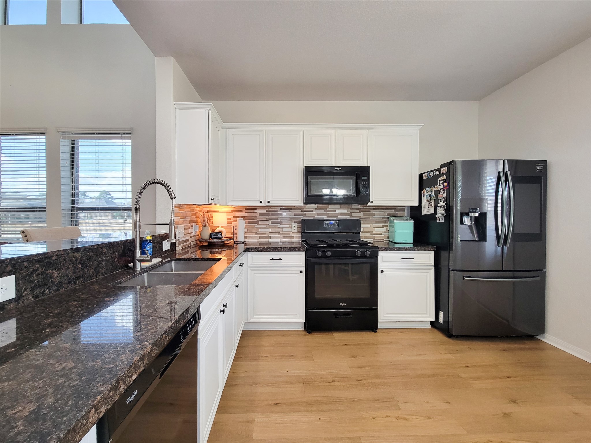 108 Sam Drive Dayton, TX 77535 - Photo 12 of 38 a kitchen with a refrigerator sink and stove