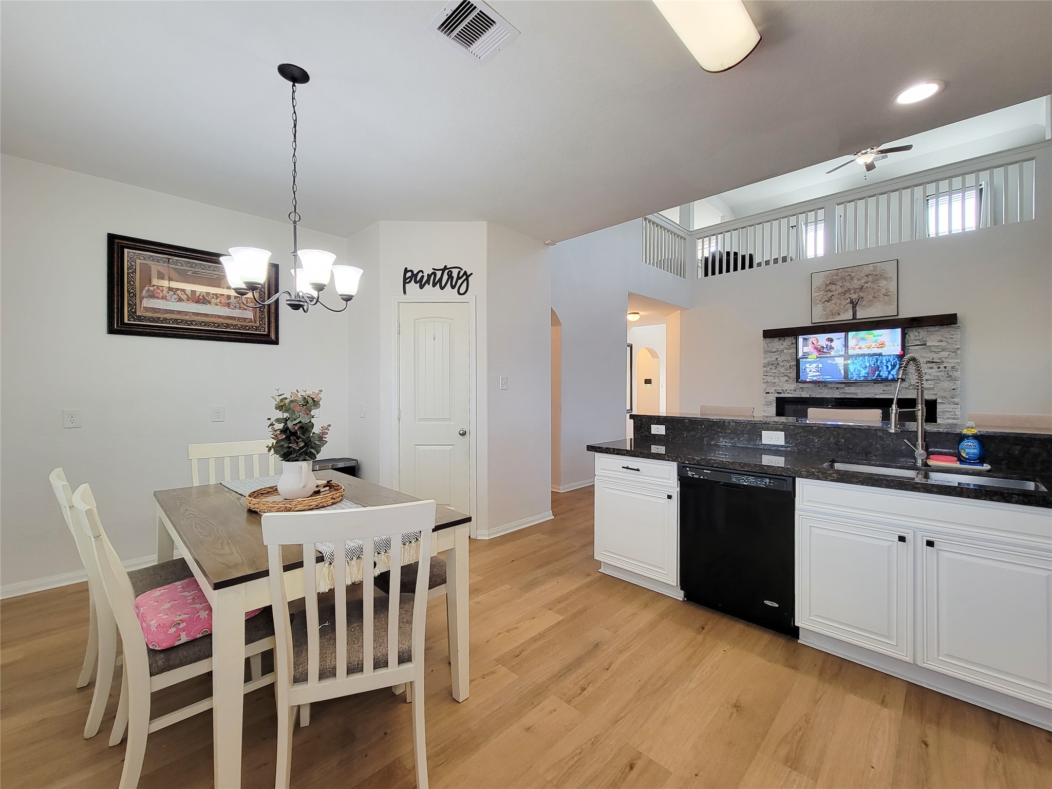 108 Sam Drive Dayton, TX 77535 - Photo 14 of 38 a kitchen with stainless steel appliances granite countertop a sink a stove a microwave a dining table and chairs