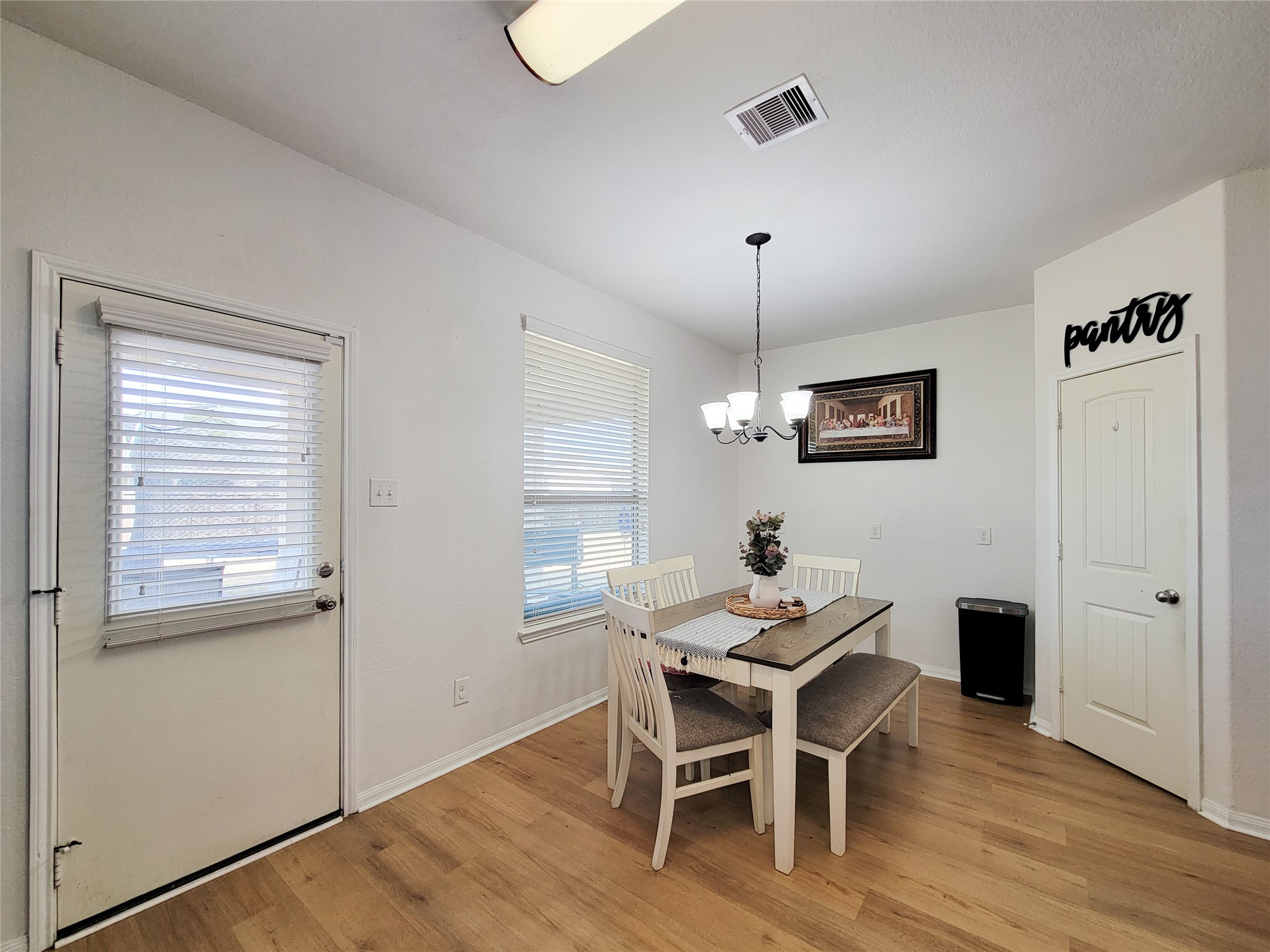 108 Sam Drive Dayton, TX 77535 - Photo 15 of 38 a dining room with furniture a chandelier and wooden floor