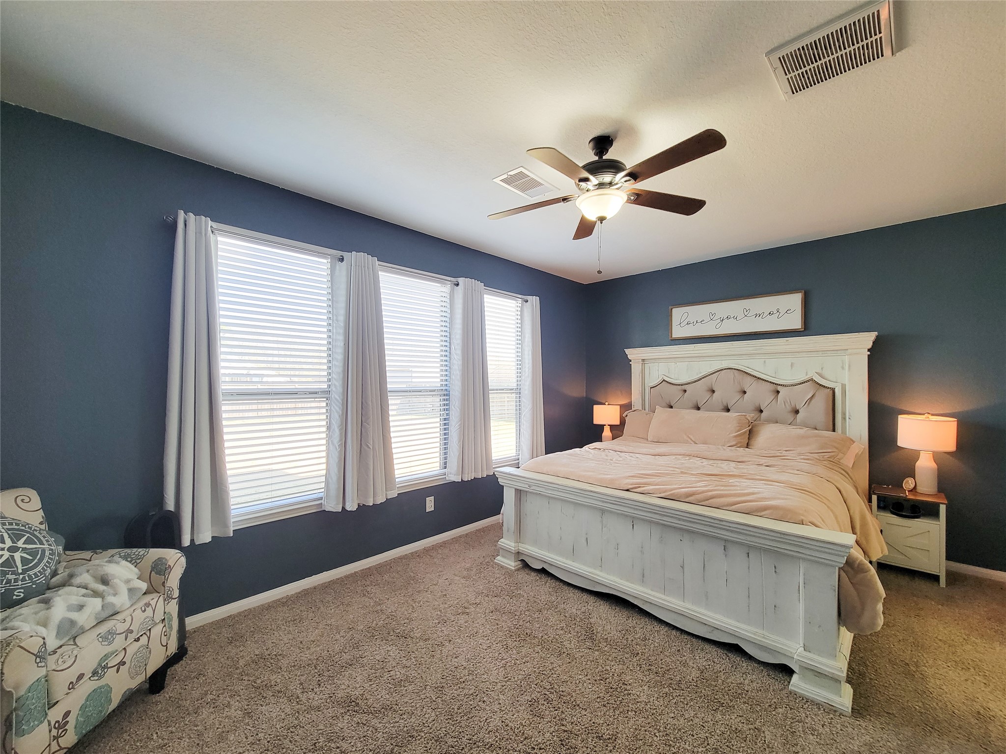 108 Sam Drive Dayton, TX 77535 - Photo 18 of 38 a spacious bedroom with a bed and a chandelier