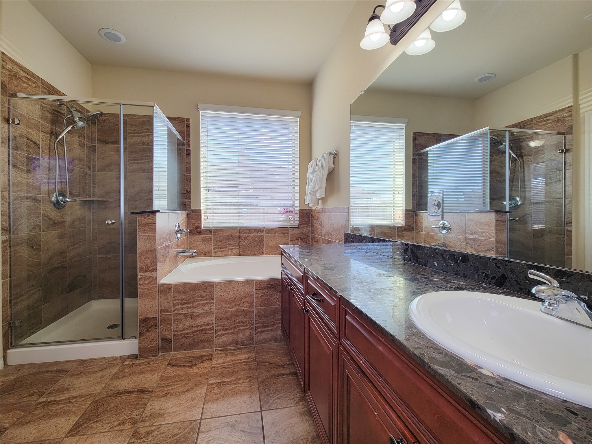 108 Sam Drive Dayton, TX 77535 - Photo 19 of 38 a bathroom with a granite countertop sink a mirror and a shower