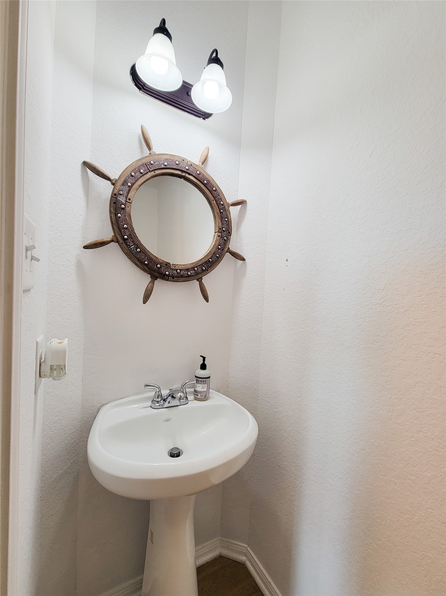 108 Sam Drive Dayton, TX 77535 - Photo 32 of 38 a bathroom with a sink a mirror and a light fixture