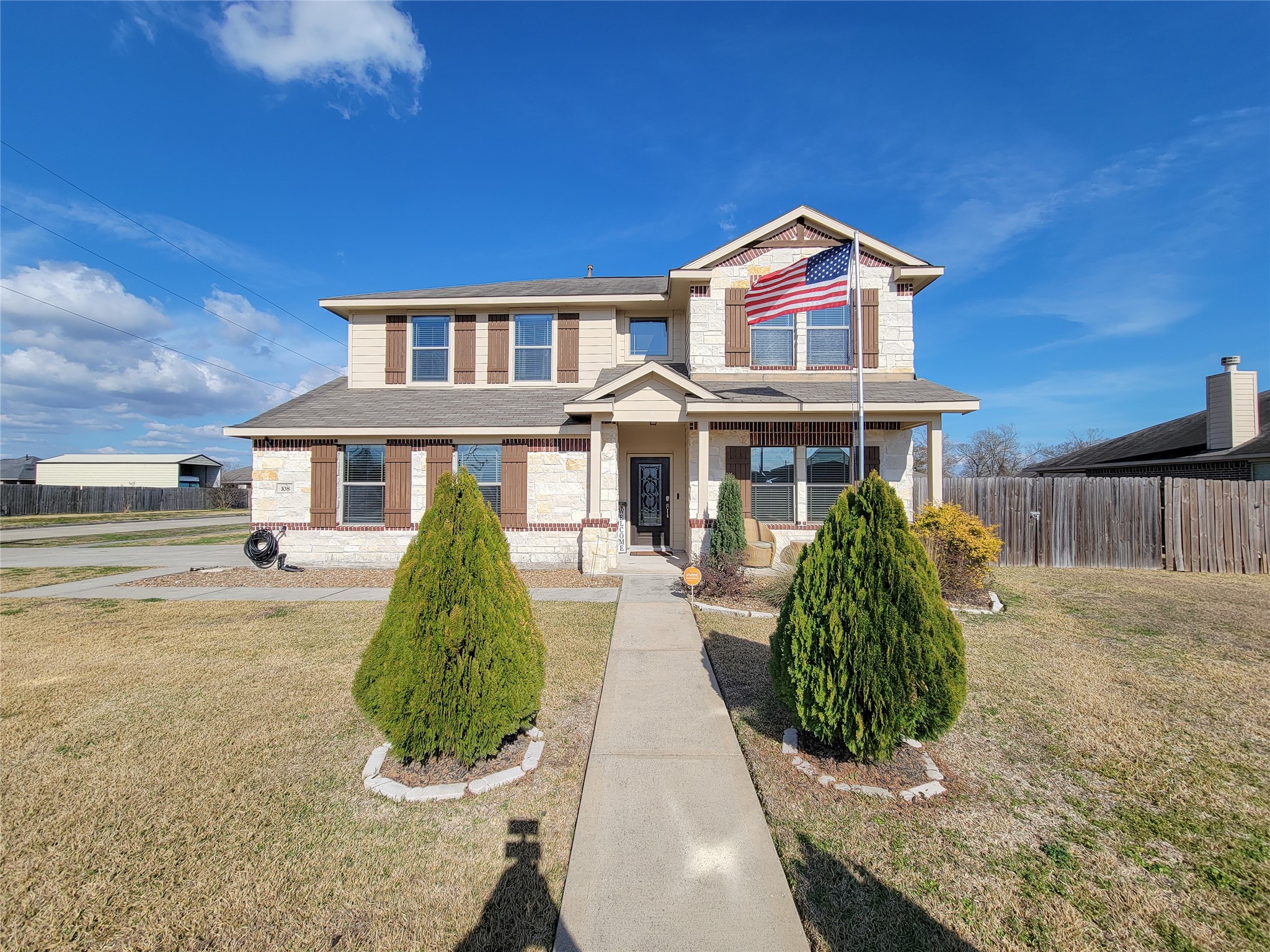 108 Sam Drive Dayton, TX 77535 - Photo 4 of 38 a front view of a house with a yard and potted plants