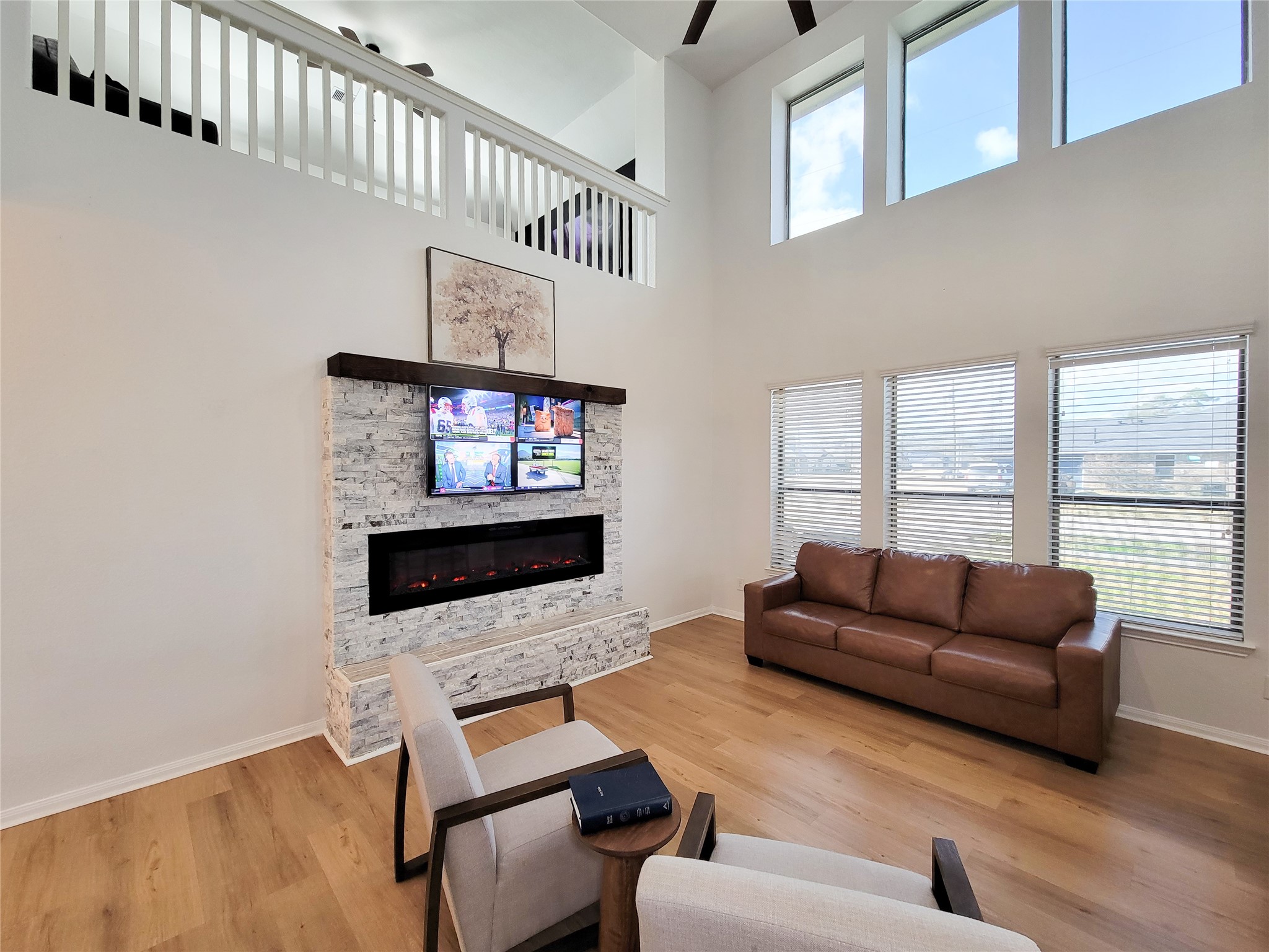 108 Sam Drive Dayton, TX 77535 - Photo 9 of 38 a living room with furniture a flat screen tv and a floor to ceiling window