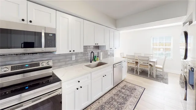 a kitchen with a stove a sink and a microwave