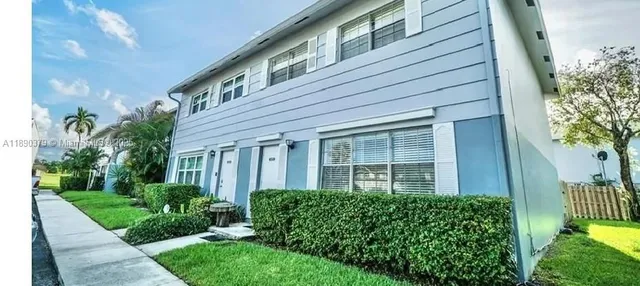 a view of a house with a yard and plants
