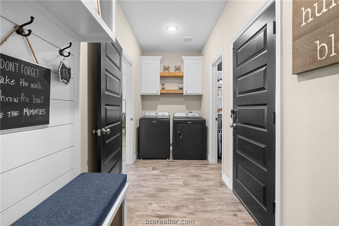 3222 Hunters Crossing Bryan, TX 77808 - Photo 27 of 44 Laundry area with light wood finished floors, cabinet space, and washing machine and dryer