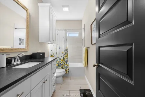 a kitchen with a refrigerator and a sink