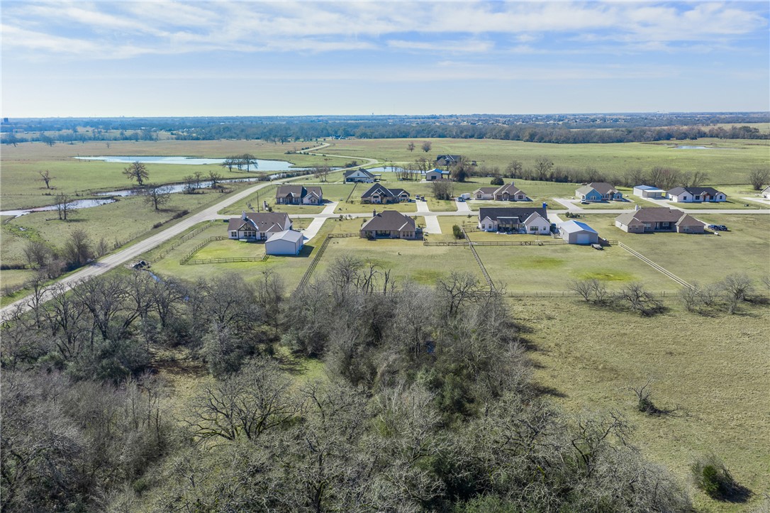 3222 Hunters Crossing Bryan, TX 77808 - Photo 41 of 44 Aerial view of property from the rear looking to the front of property showing the wooded area with creek at the edge propertie's rear boundary.