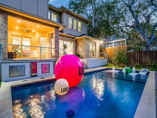 a swimming pool with outdoor seating and yard