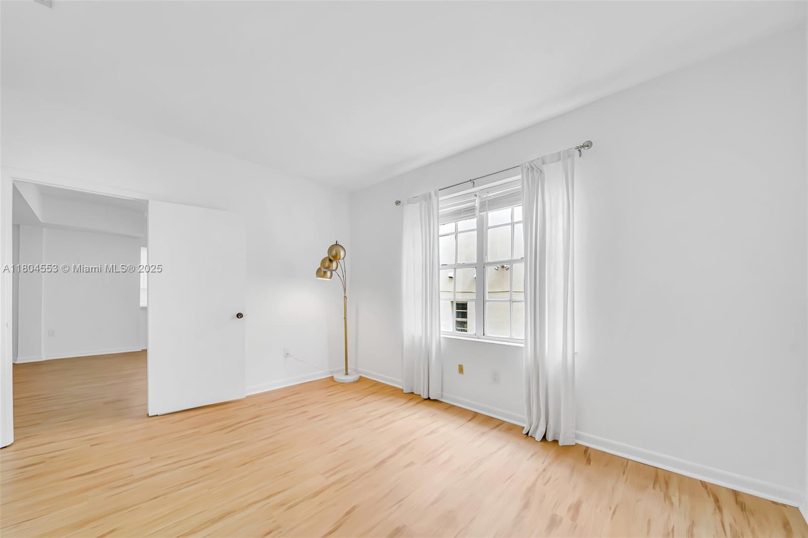 1051 Meridian Avenue, Unit 1D Miami Beach, FL 33139 - Photo 9 of 16 a view of empty room with wooden floor and fan