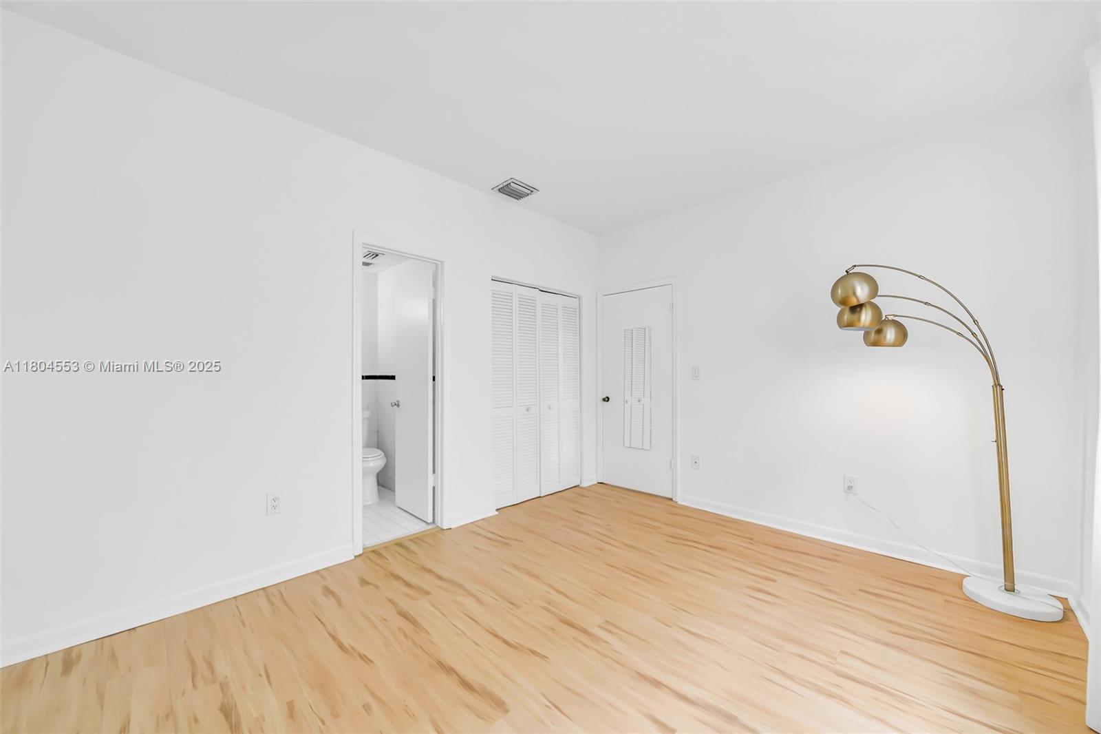 1051 Meridian Avenue, Unit 1D Miami Beach, FL 33139 - Photo 10 of 16 a view of empty room with wooden floor