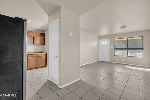 a view of a kitchen cabinets and a refrigerator
