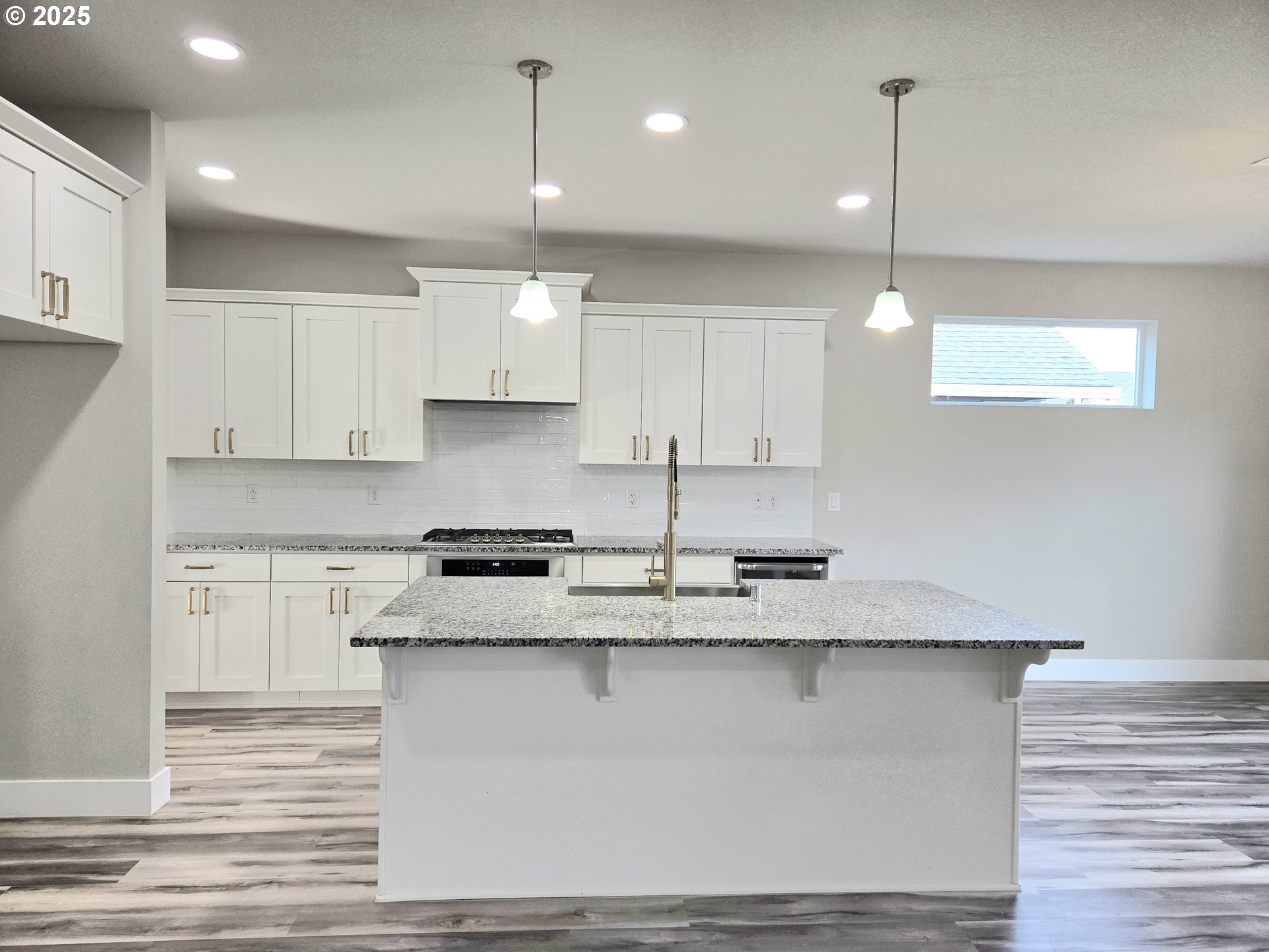 8524 North 1st Street Ridgefield, WA 98642 - Photo 13 of 48 a kitchen with kitchen island granite countertop a sink cabinets and stainless steel appliances