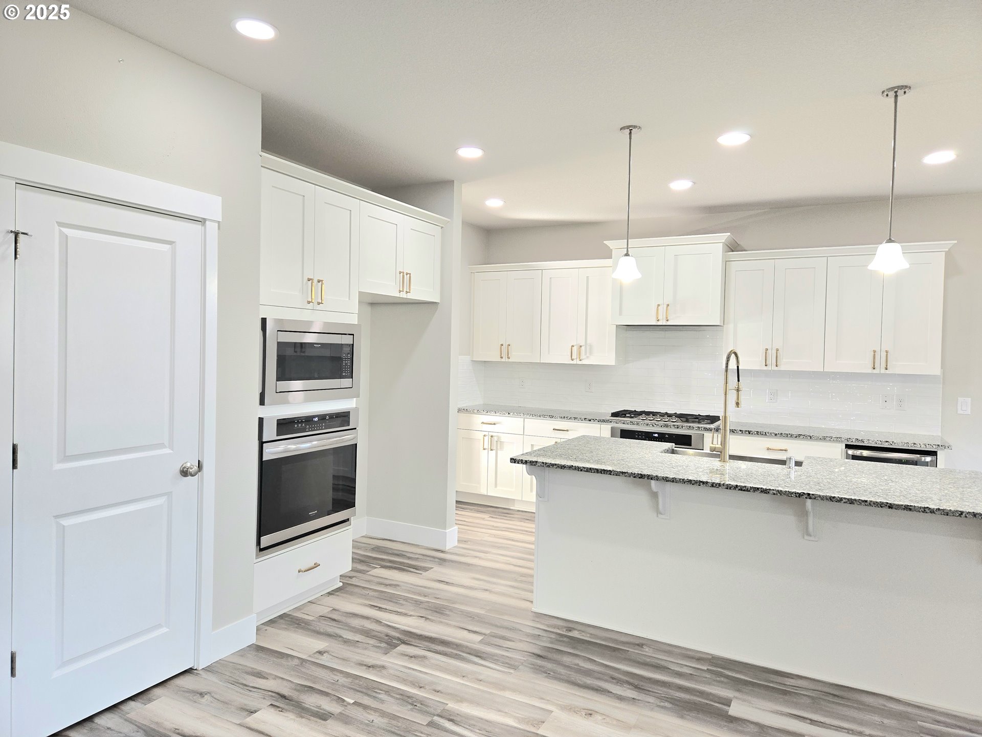 8524 North 1st Street Ridgefield, WA 98642 - Photo 14 of 48 a kitchen with stainless steel appliances granite countertop a stove a refrigerator and a sink