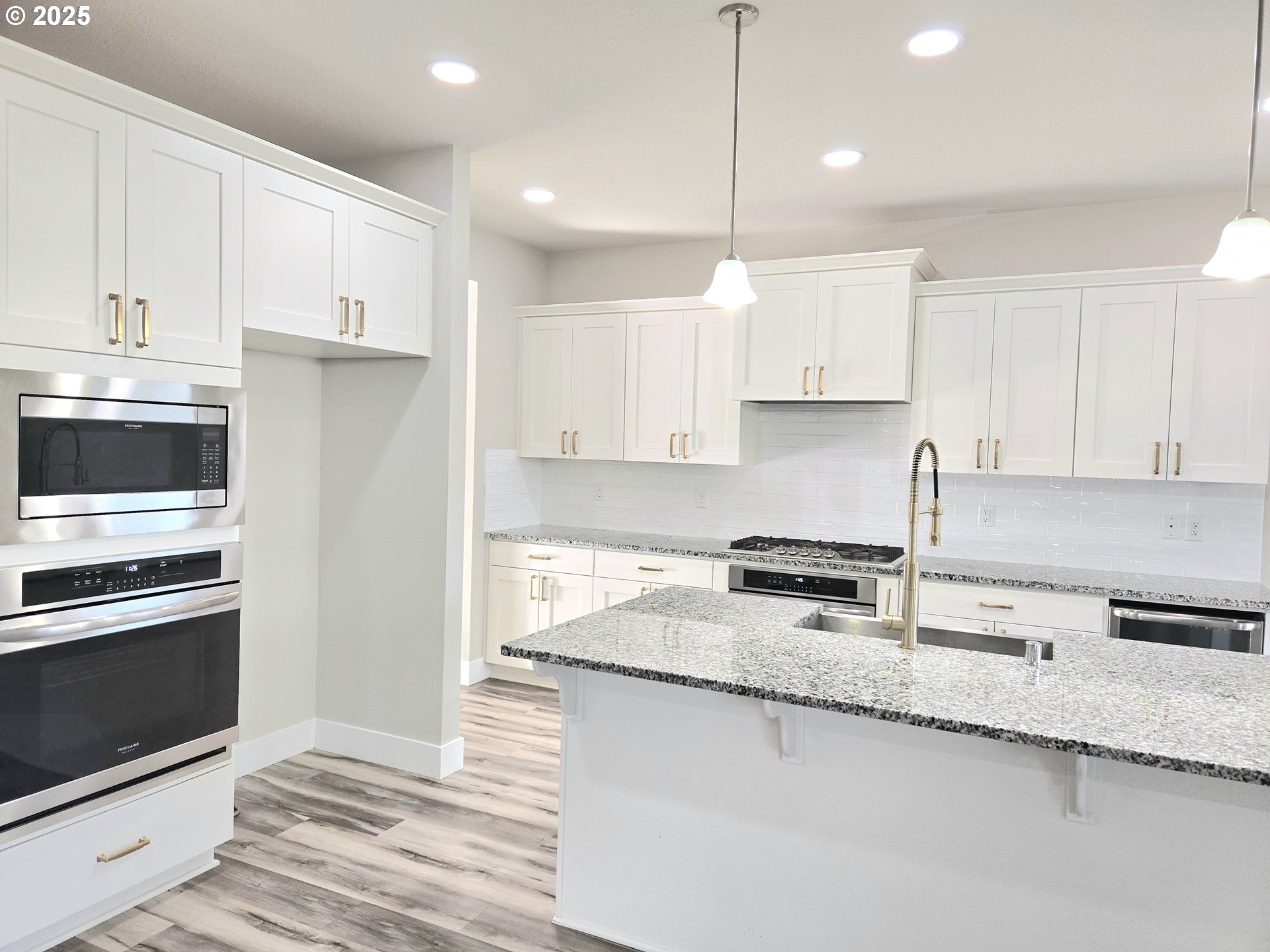 8524 North 1st Street Ridgefield, WA 98642 - Photo 15 of 48 a kitchen with granite countertop a stove a sink and a refrigerator