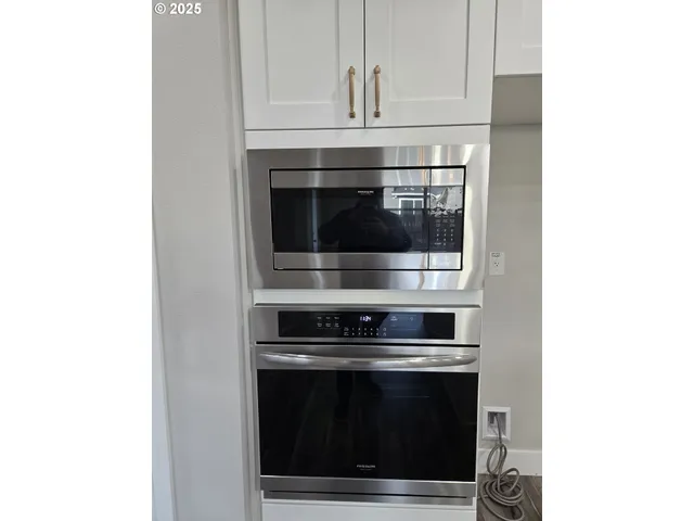 a stove top oven sitting inside of a kitchen