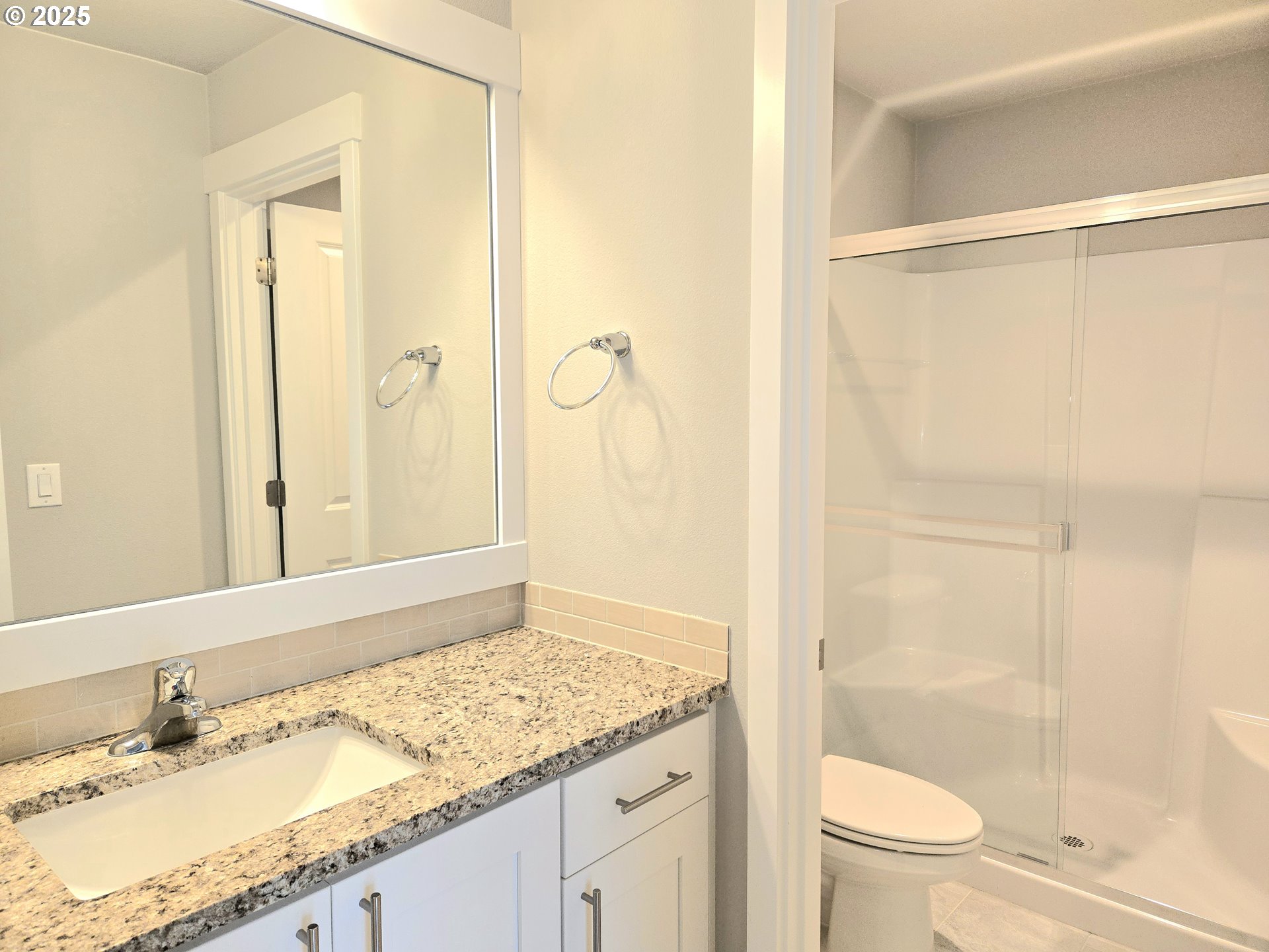 8524 North 1st Street Ridgefield, WA 98642 - Photo 35 of 48 a bathroom with a granite countertop sink toilet and shower