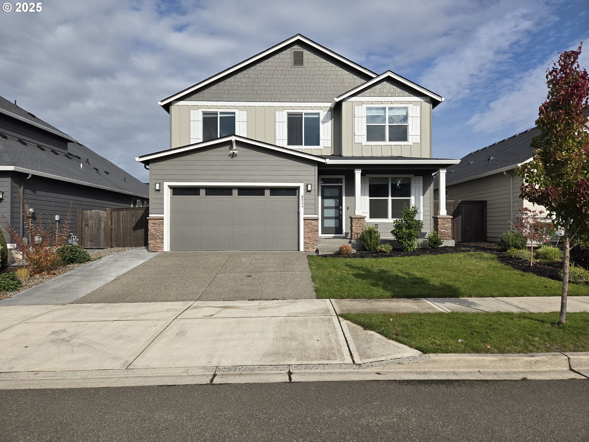 8524 North 1st Street Ridgefield, WA 98642 - Photo 48 of 48 a front view of a house with a yard and garage