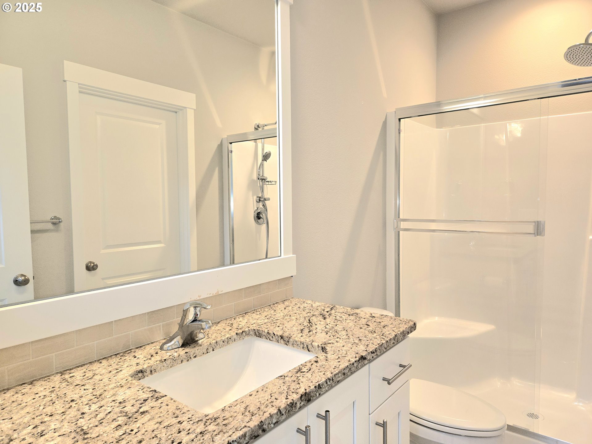 8524 North 1st Street Ridgefield, WA 98642 - Photo 5 of 48 a bathroom with a granite countertop sink toilet and shower