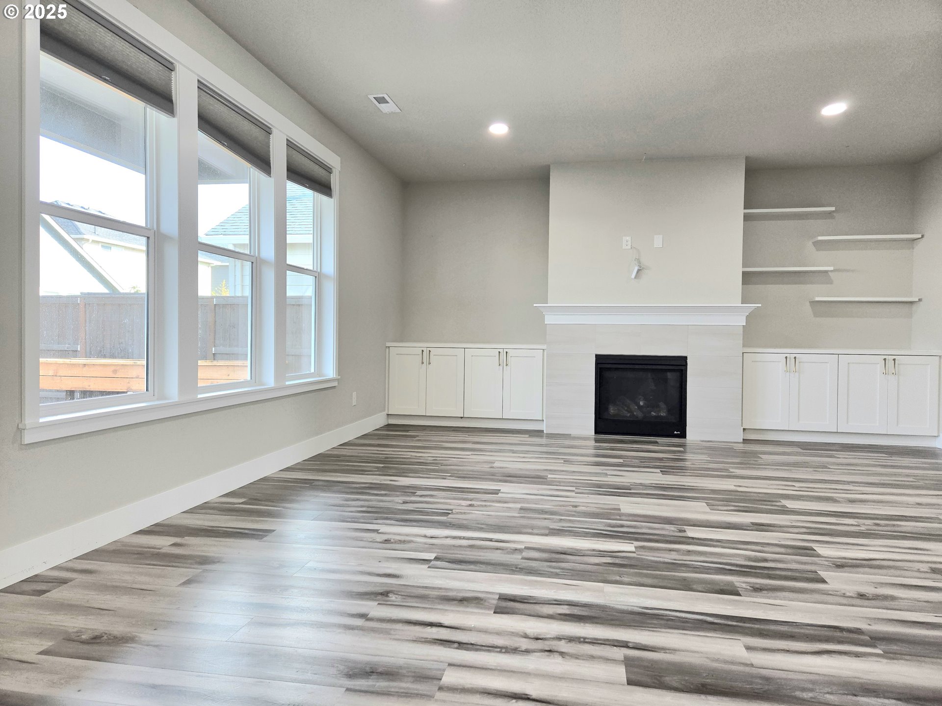 8524 North 1st Street Ridgefield, WA 98642 - Photo 7 of 48 a view of empty room with wooden floor and fireplace