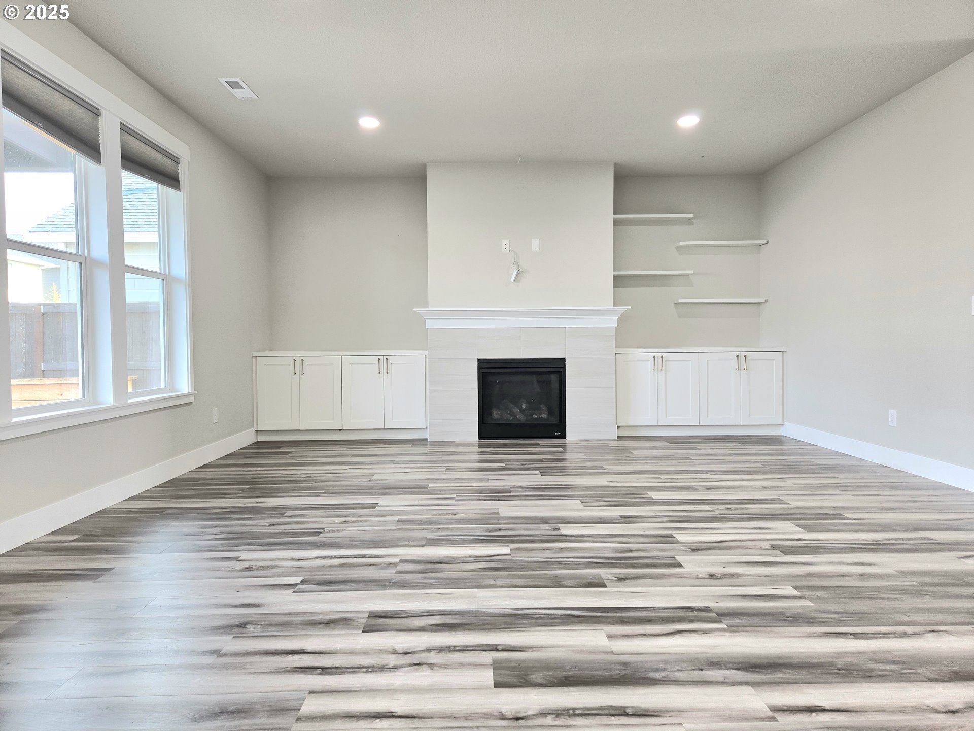 8524 North 1st Street Ridgefield, WA 98642 - Photo 8 of 48 a view of empty room with wooden floor and fireplace