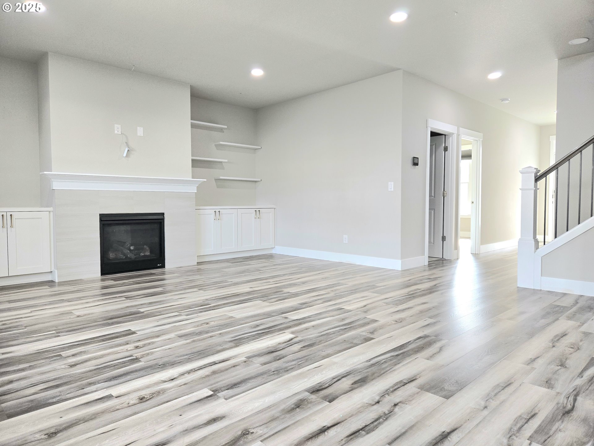 8524 North 1st Street Ridgefield, WA 98642 - Photo 9 of 48 a view of empty room with wooden floor and fireplace