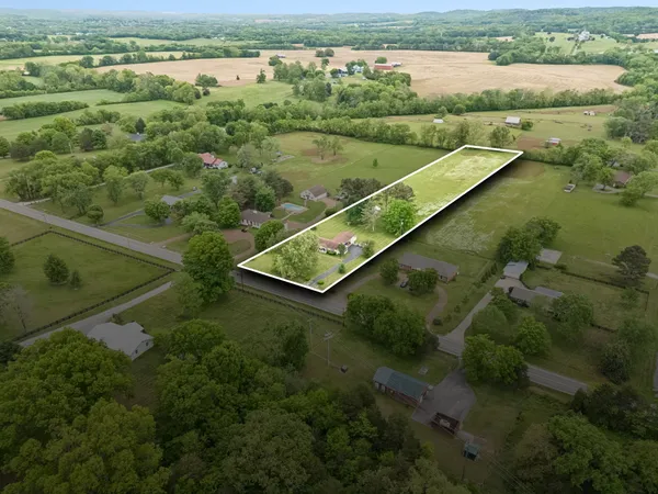 an aerial view of residential houses with outdoor space and river