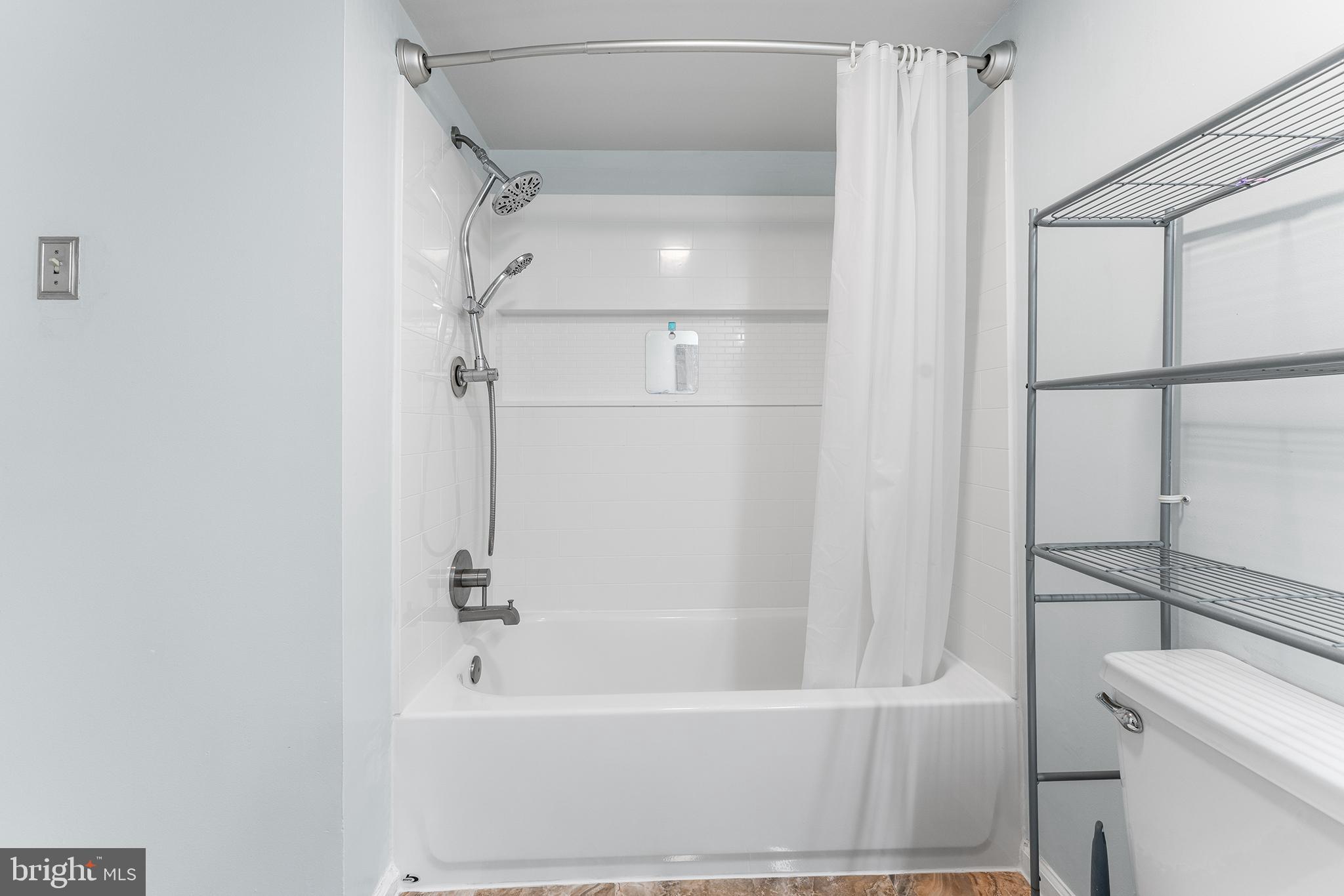 6070 Main Street Voorhees, NJ 08043 - Photo 11 of 22 a bathroom with a bathtub and a shower