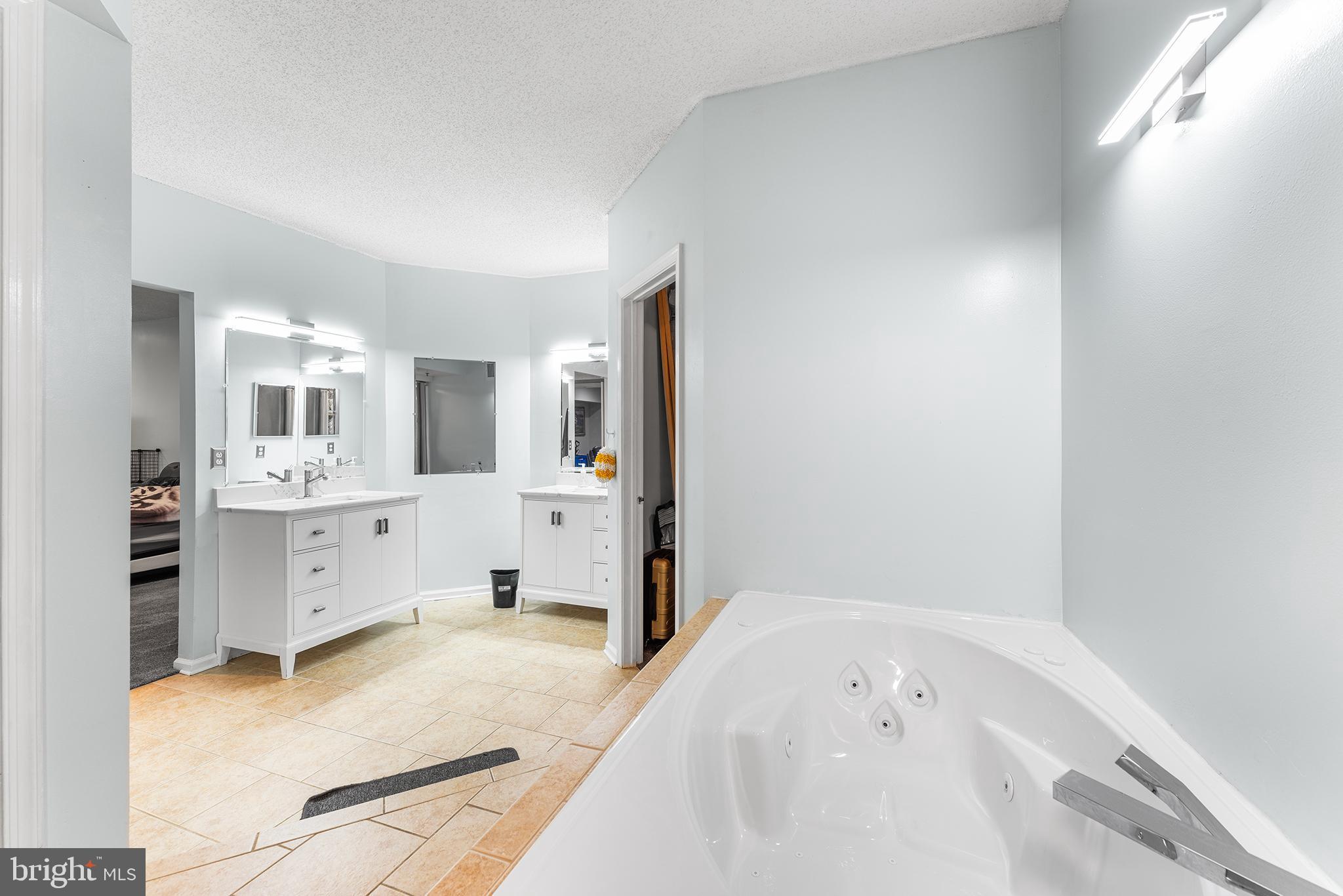 6070 Main Street Voorhees, NJ 08043 - Photo 15 of 22 a bathroom with a bathtub sink and mirror