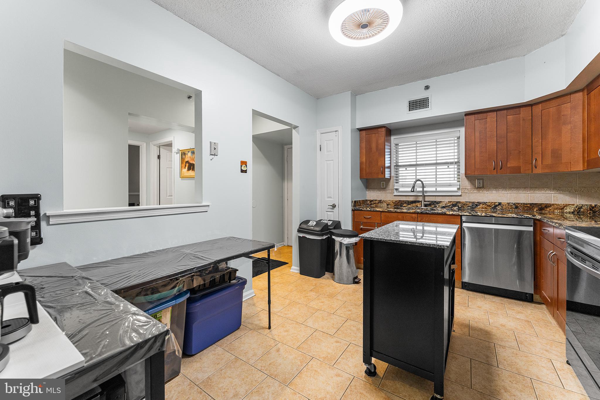 6070 Main Street Voorhees, NJ 08043 - Photo 5 of 22 a kitchen with stainless steel appliances granite countertop a stove a sink dishwasher and a refrigerator with wooden cabinets