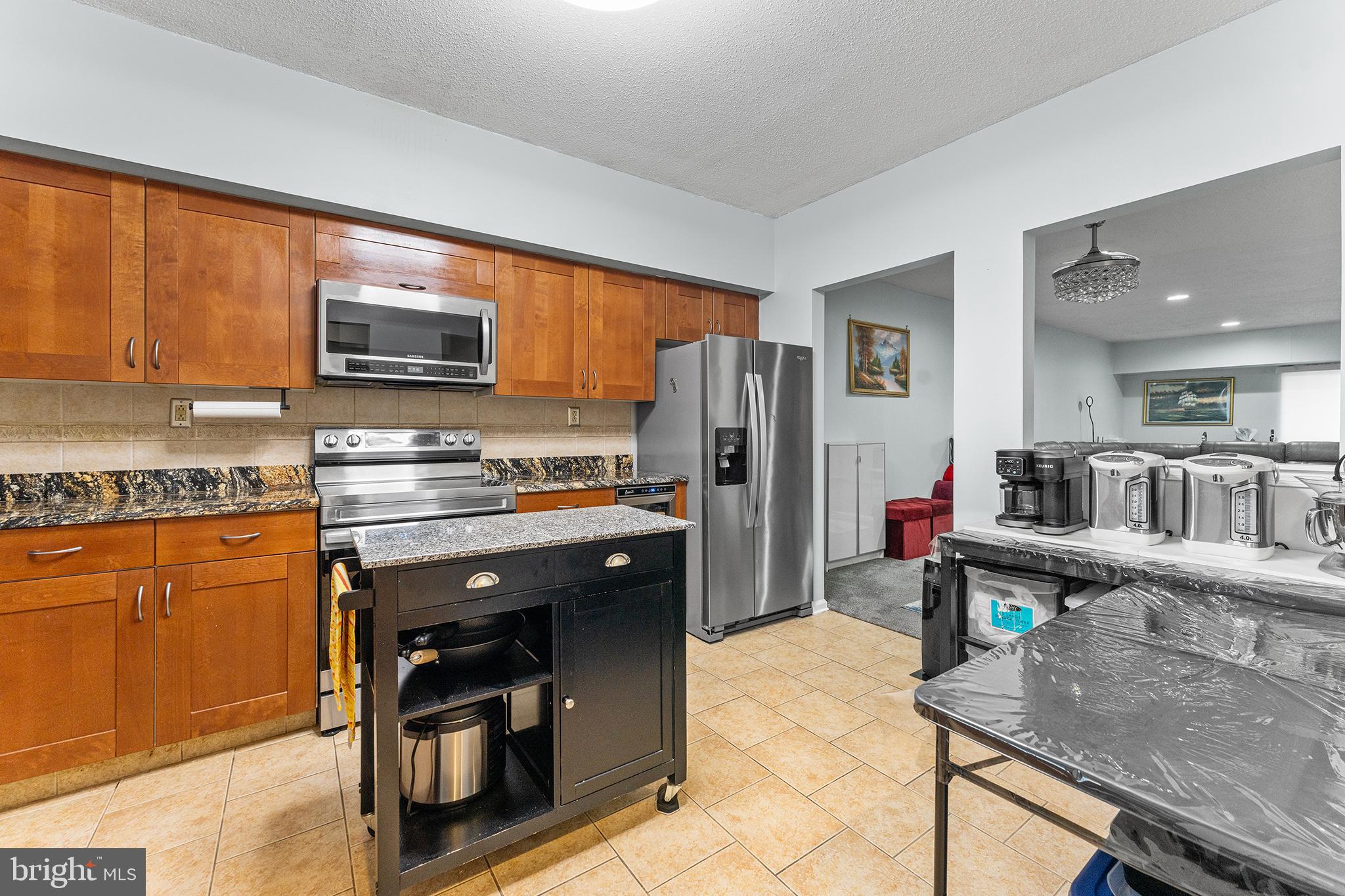 6070 Main Street Voorhees, NJ 08043 - Photo 8 of 22 a kitchen with stainless steel appliances a stove refrigerator sink and microwave