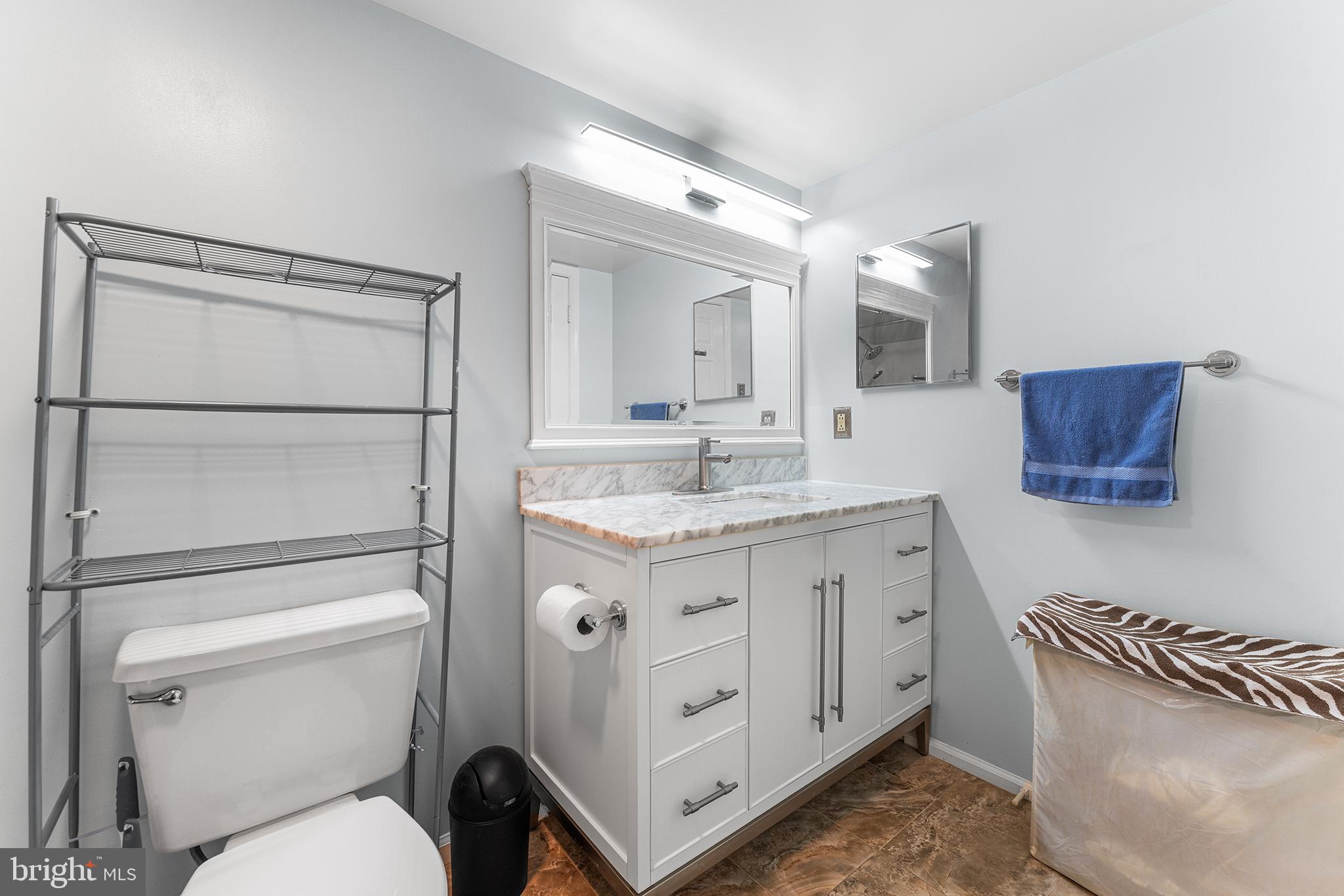 6070 Main Street Voorhees, NJ 08043 - Photo 10 of 22 a bathroom with a granite countertop toilet sink and mirror