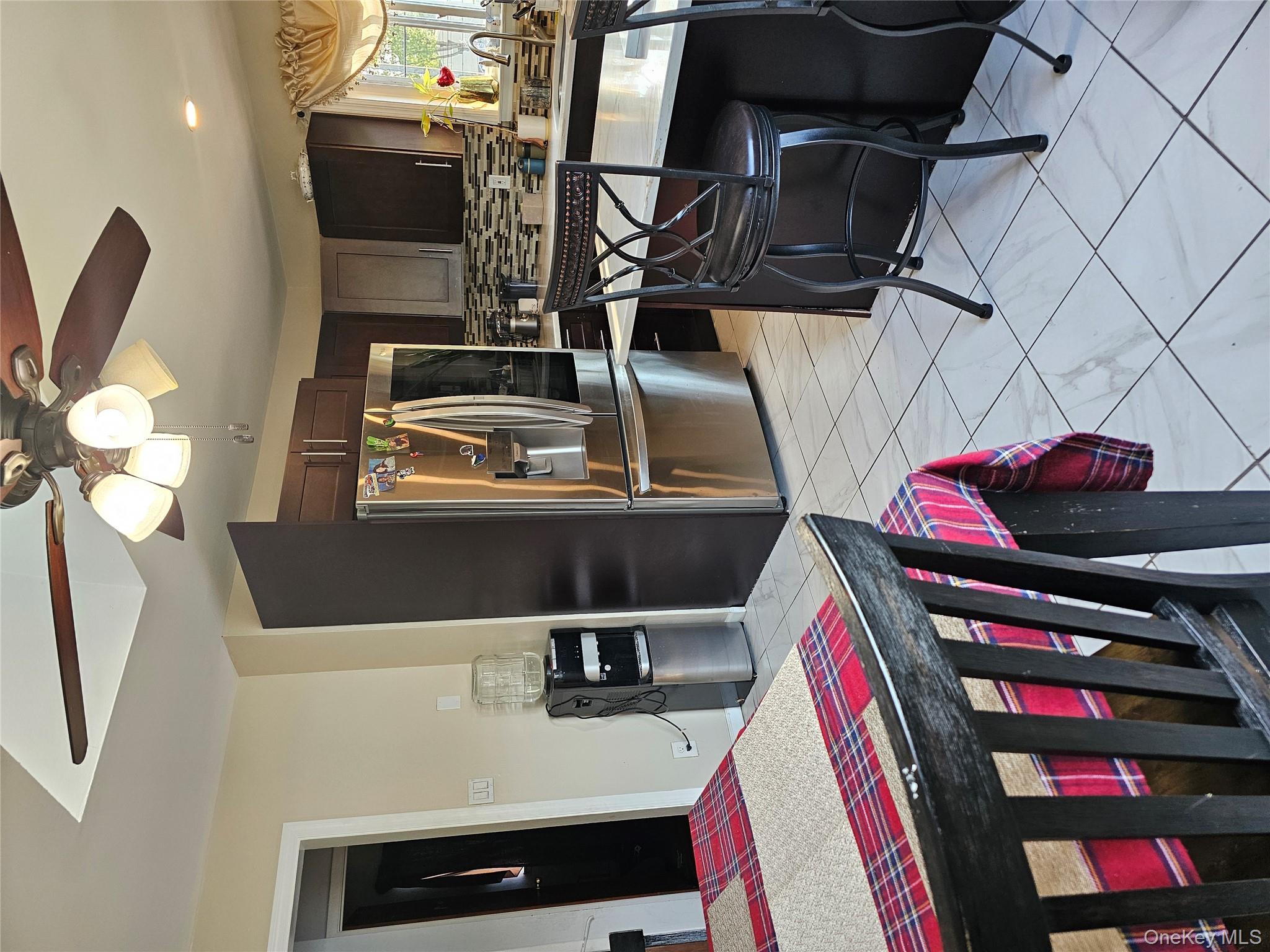 2 Mortell Court Babylon, NY 11726 - Photo 6 of 12 a kitchen with stainless steel appliances kitchen island granite countertop a sink refrigerator and cabinets