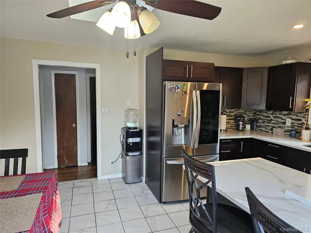 a kitchen with a refrigerator a stove a sink and a dining table