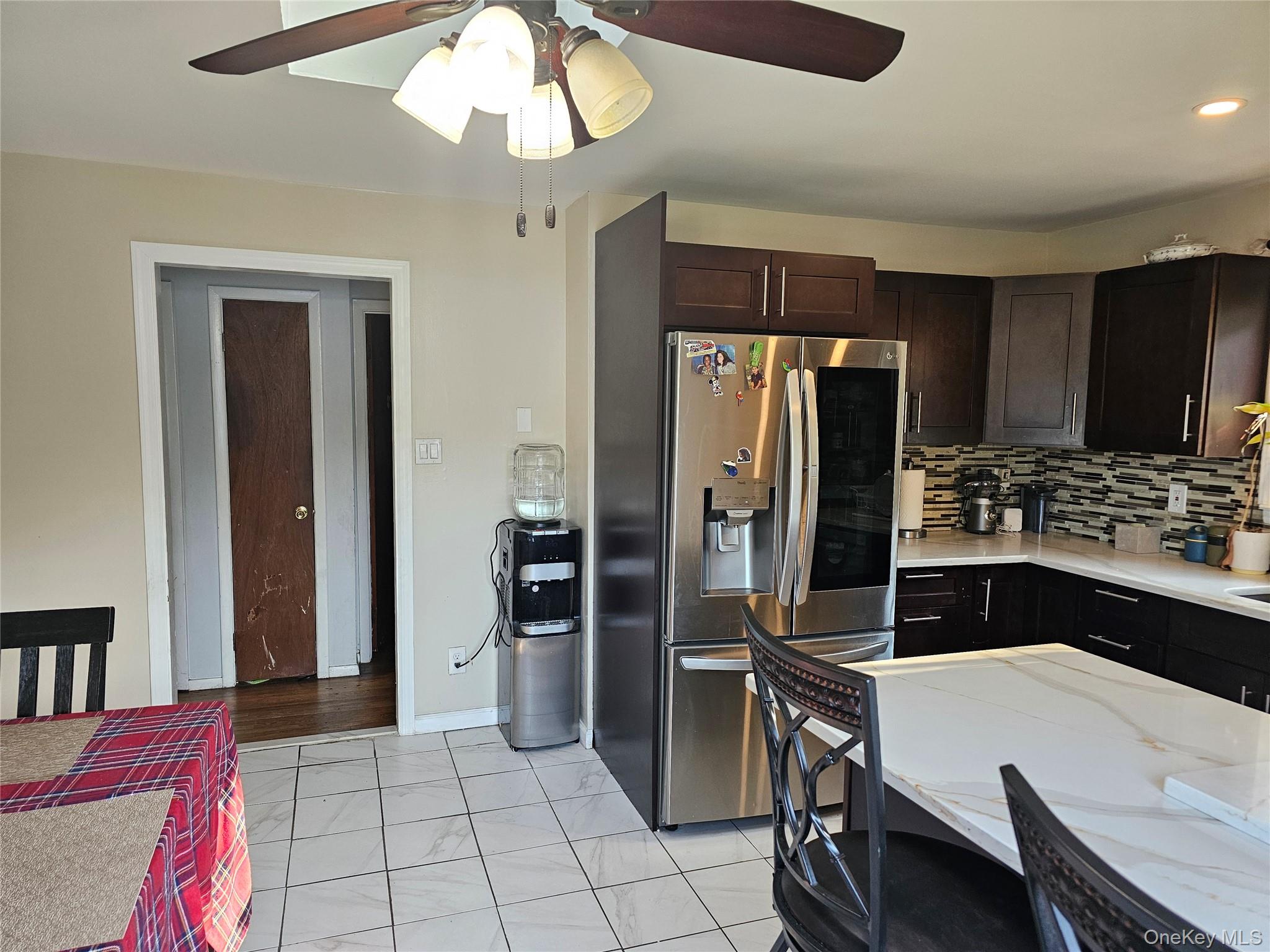 2 Mortell Court Babylon, NY 11726 - Photo 7 of 12 a kitchen with a refrigerator a stove a sink and a dining table