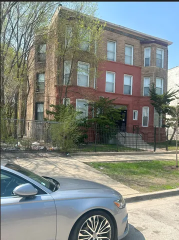 a view of a brick building next to a yard