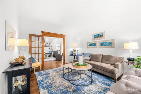 a living room with furniture a rug and a lamp