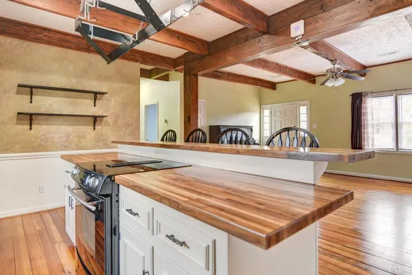a view of a kitchen with a sink and wooden floor