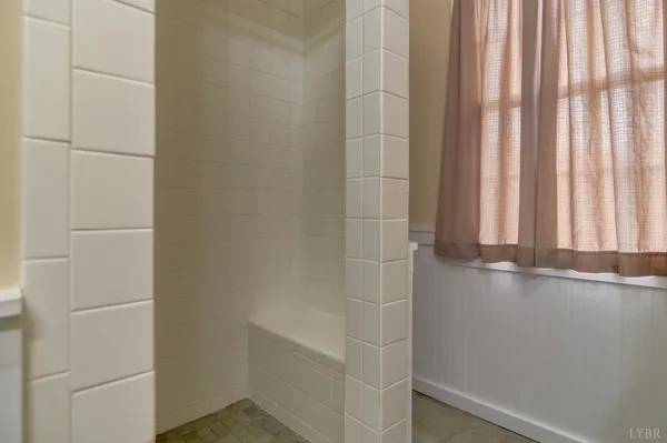 a bathroom with a window and a shower