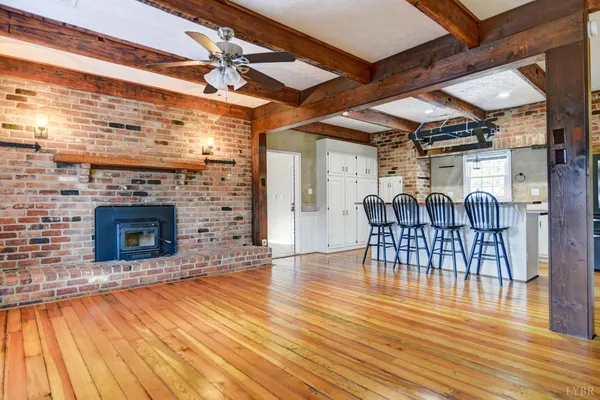 a view of a livingroom with fireplace and furniture
