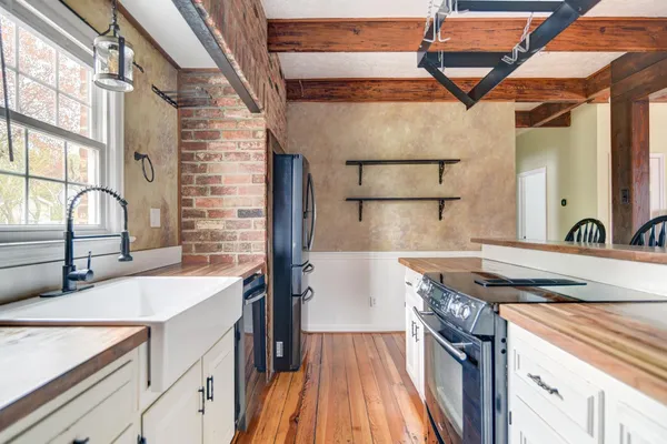 a kitchen with a sink stove and cabinets