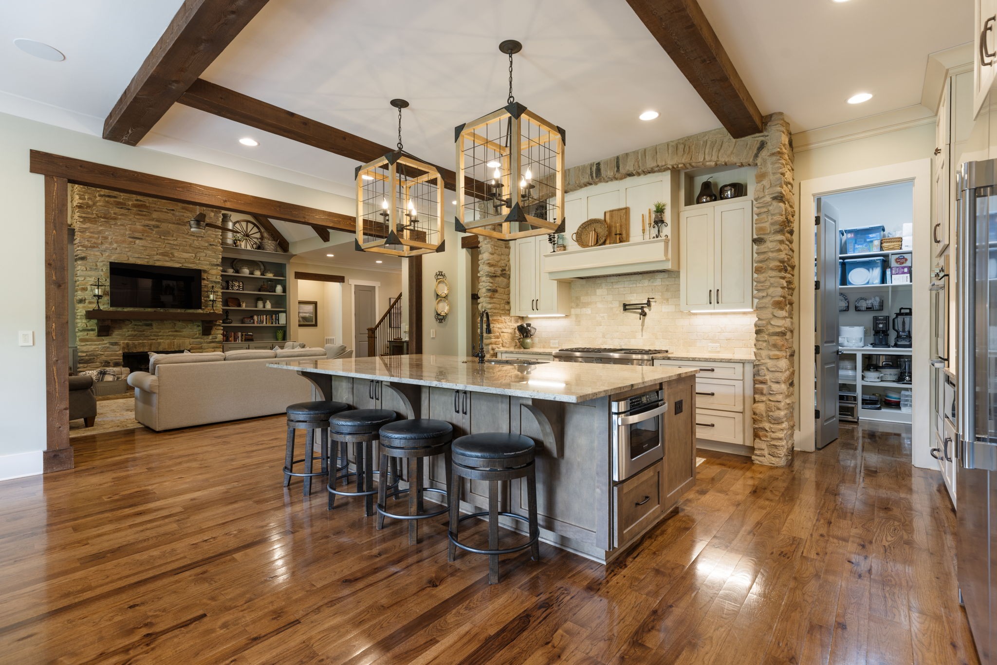 641 Legends Crest Drive Franklin, TN 37069 - Photo 4 of 99 a kitchen with stainless steel appliances granite countertop a stove refrigerator and a dining table with wooden floor