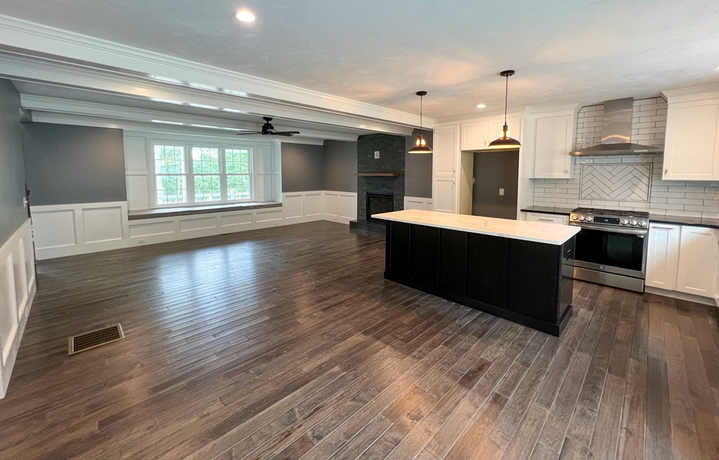 242 East County Road Rutland, MA 01543 - Photo 11 of 35 a large kitchen with wooden floors and stainless steel appliances