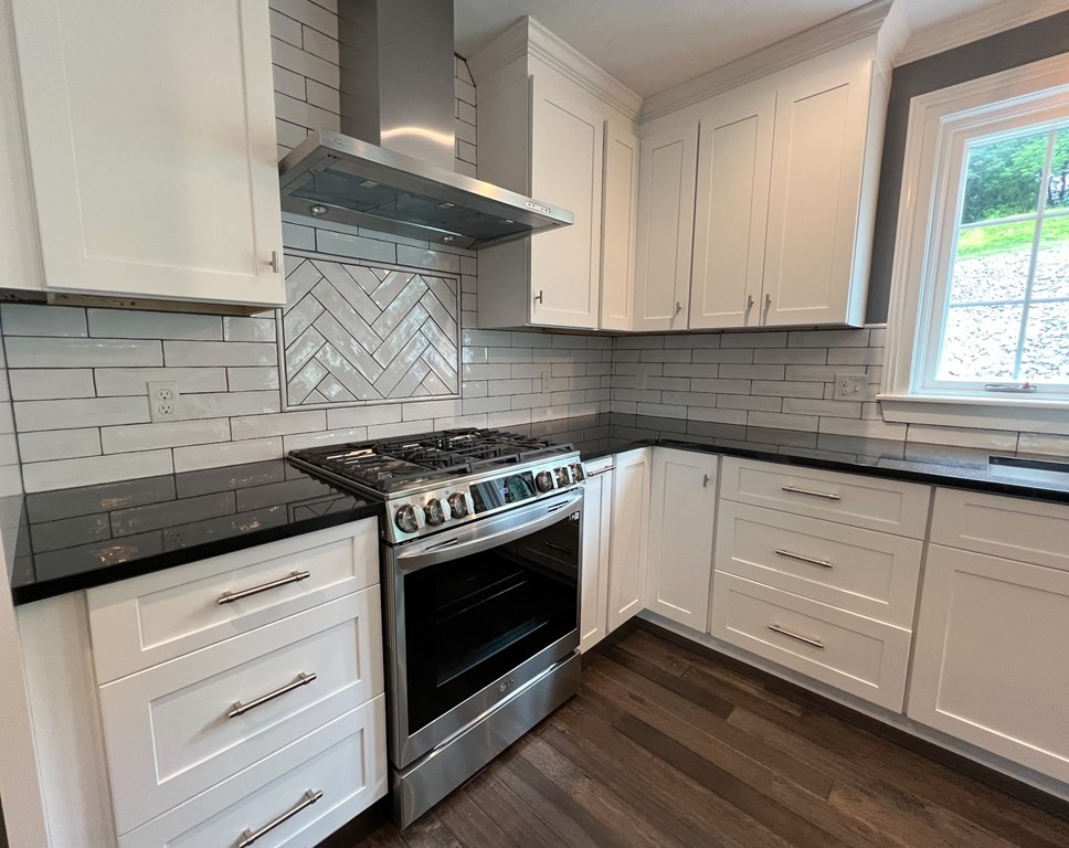 242 East County Road Rutland, MA 01543 - Photo 14 of 35 a white stove top oven sitting inside of a kitchen