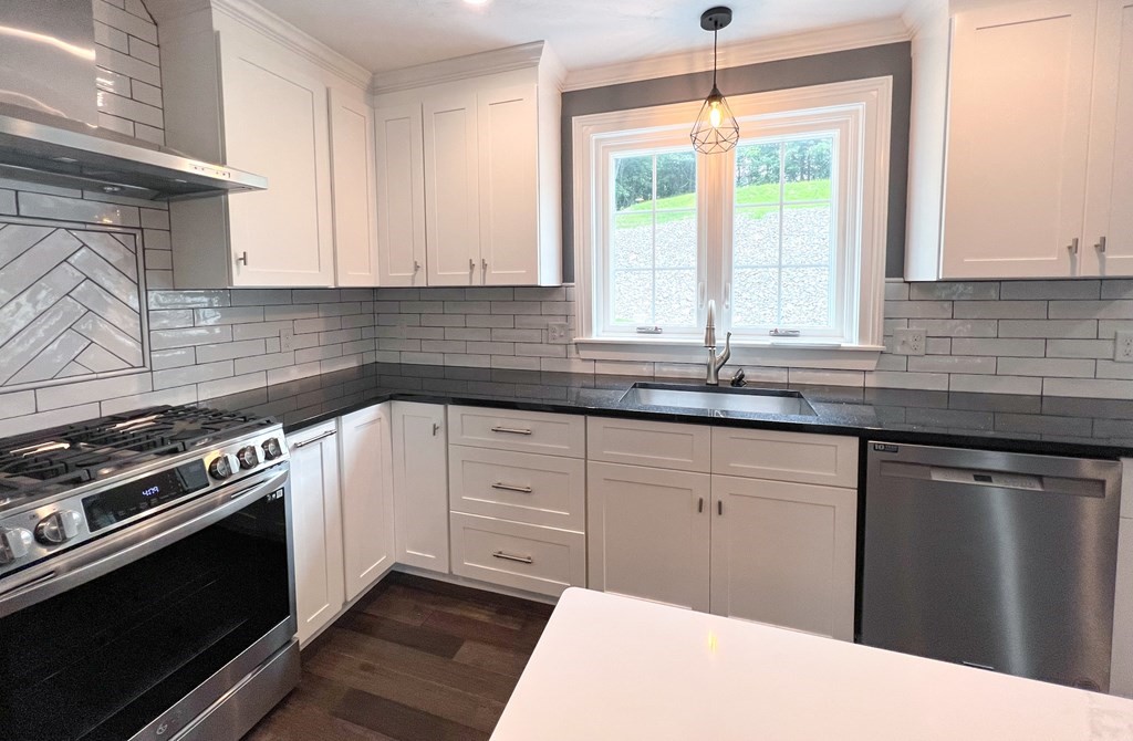 242 East County Road Rutland, MA 01543 - Photo 15 of 35 a kitchen with a sink stove and cabinets