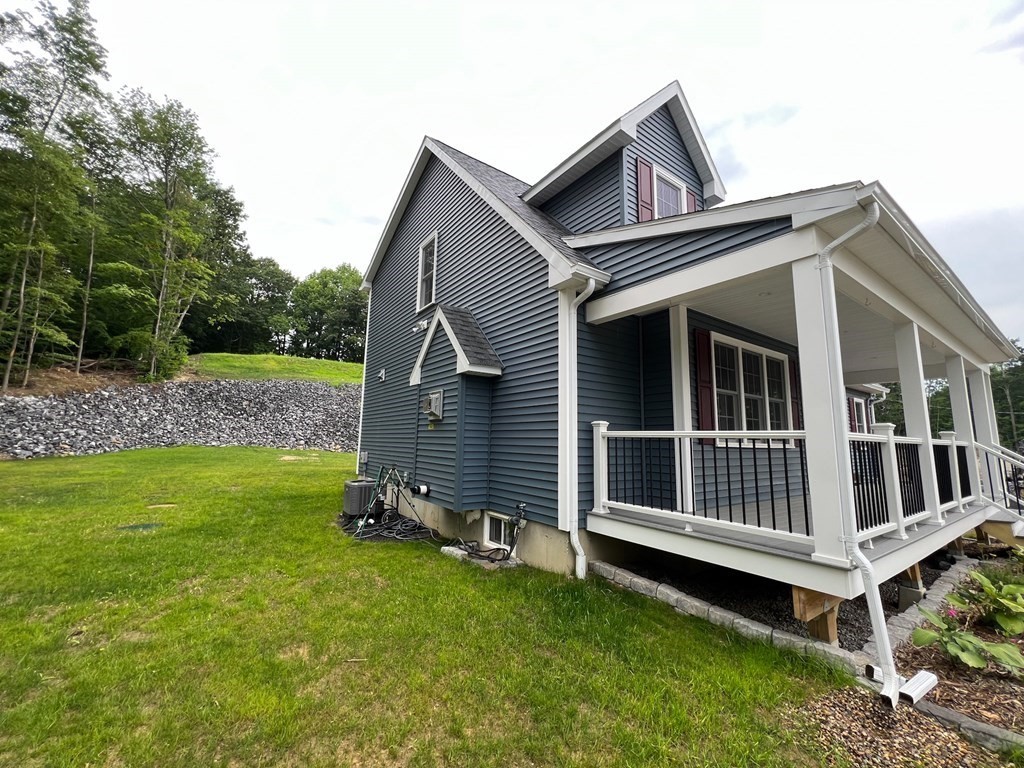 242 East County Road Rutland, MA 01543 - Photo 2 of 35 a front view of a house with a garden