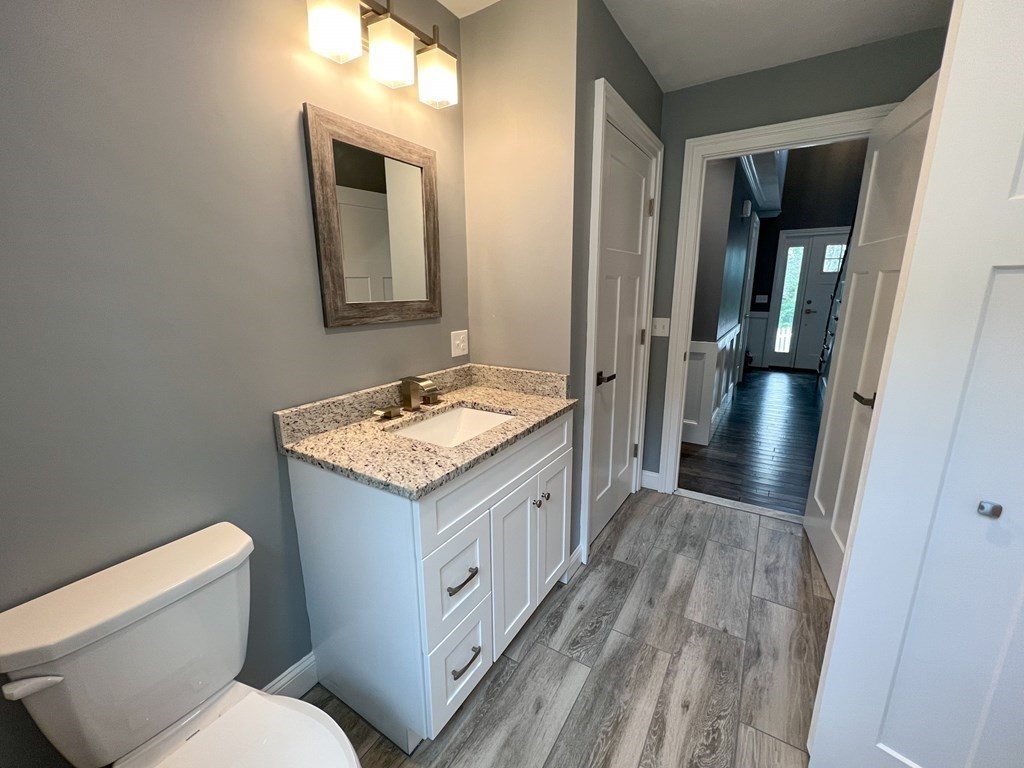 242 East County Road Rutland, MA 01543 - Photo 26 of 35 a bathroom with a granite countertop sink toilet and shower a mirror