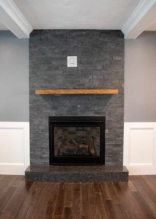 242 East County Road Rutland, MA 01543 - Photo 10 of 35 a fireplace with a clock on wooden floor
