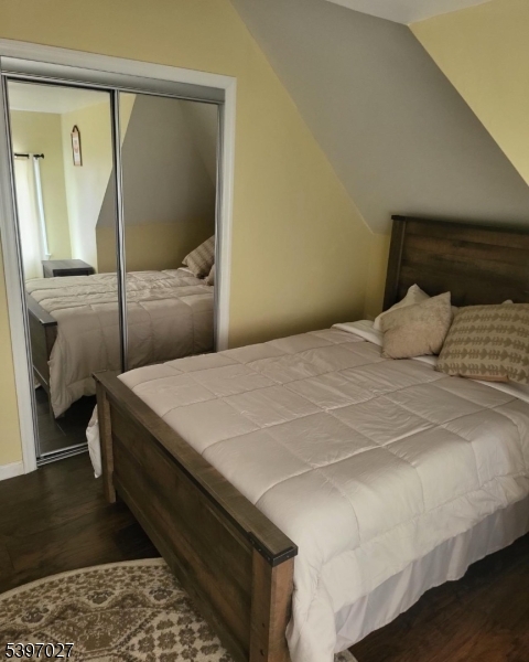 1371 Clinton Avenue Irvington, NJ 07111 - Photo 11 of 41 a bedroom with a bed and a mirror